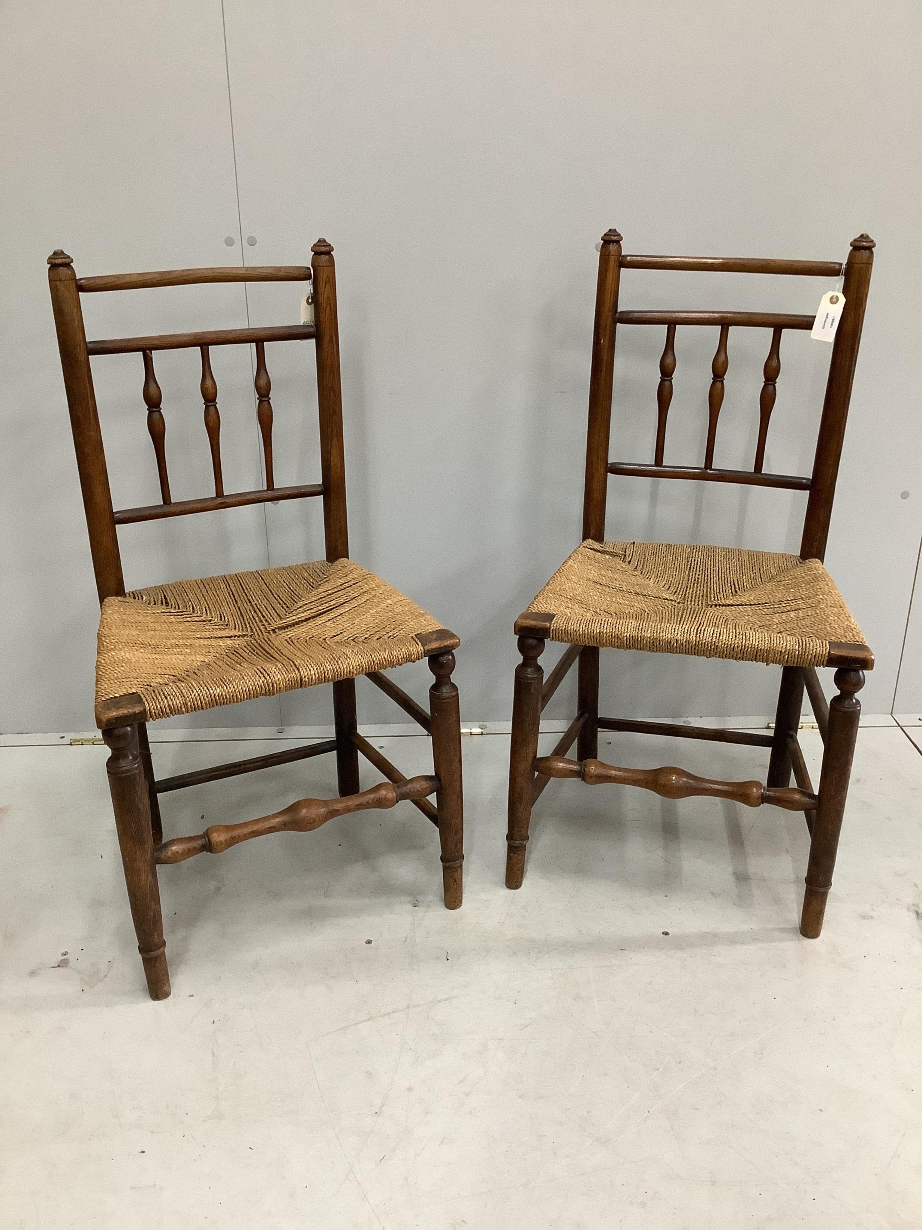 A pair of early 19th century provincial ash rush seat dining chairs, height 94cm